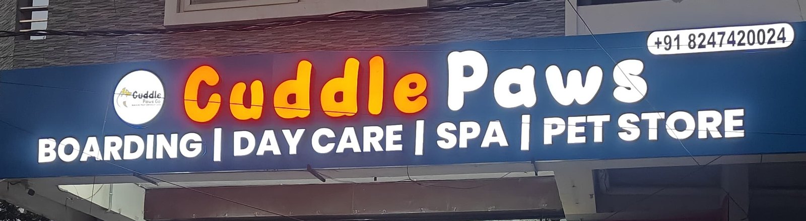 The Cuddle Paws Co signboard at our Vijay Nagar Colony shop in Hyderabad: boarding, day care, spa and pet store